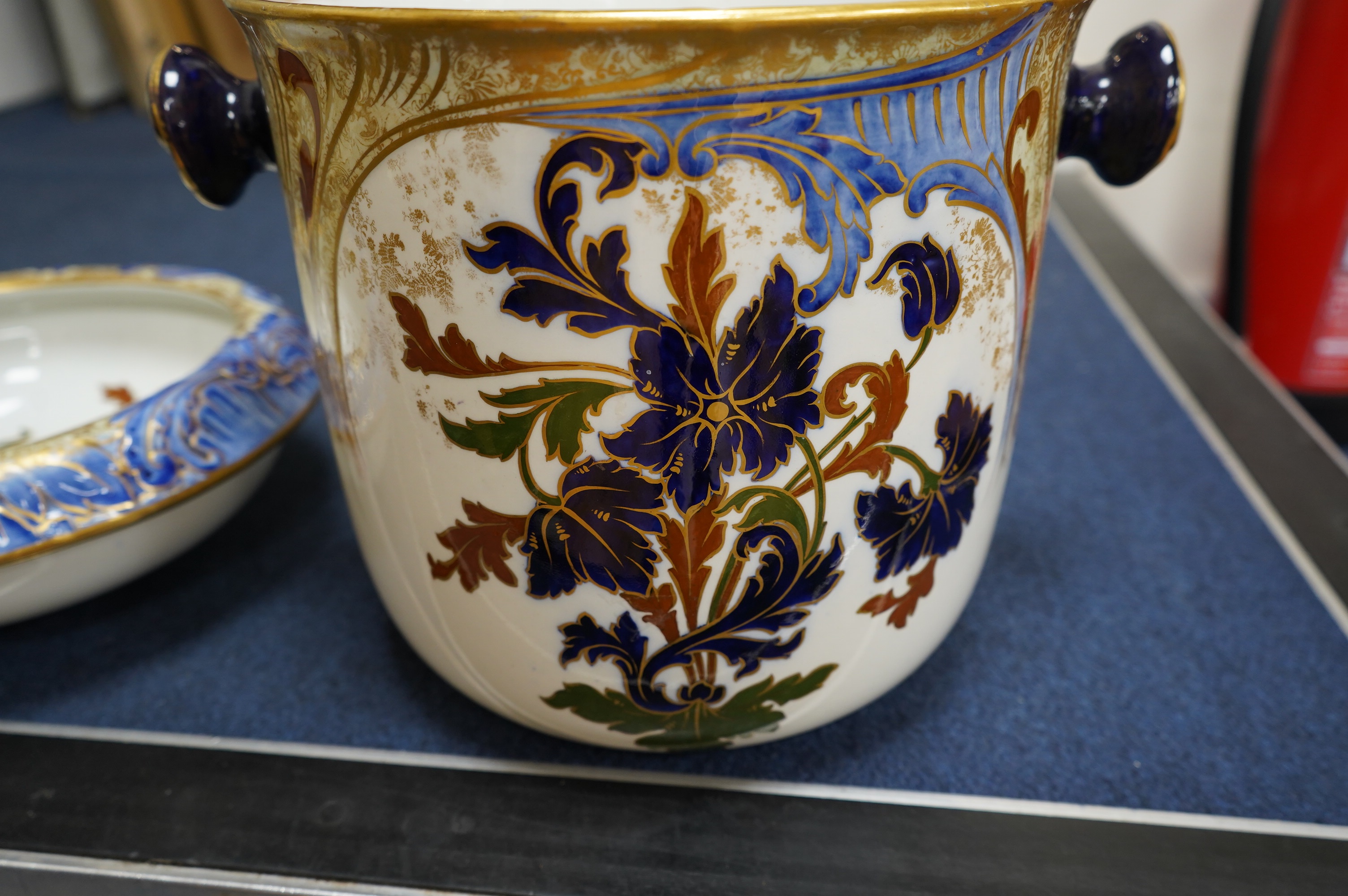A Victorian Royal Doulton gilt and floral decorated pail, 28cm high. Condition - poor, crack to back